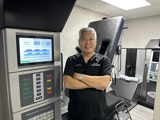 Chiropractor Carrollton TX Hoa Nguyen With DRX9000 Machine