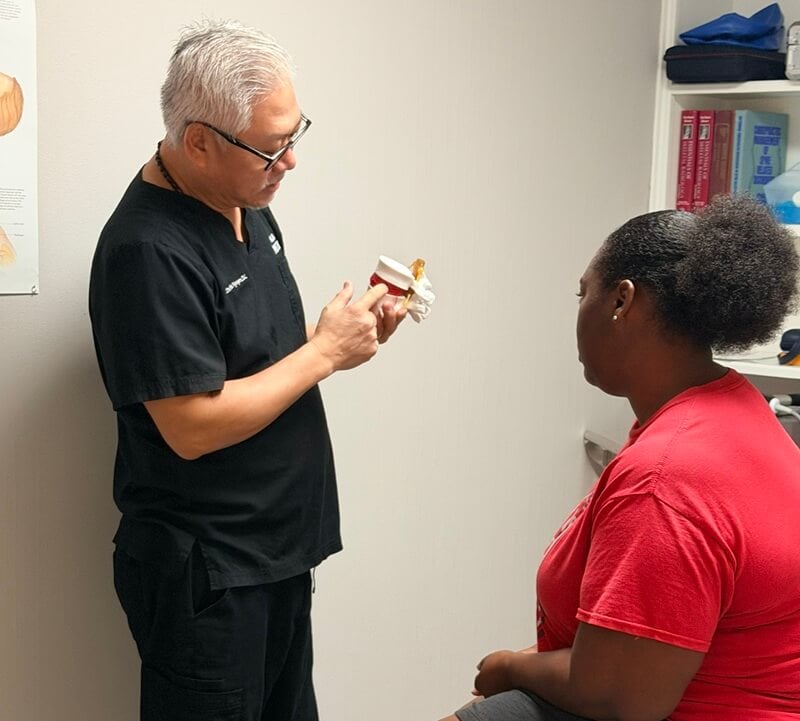 Dr. Nguyen explaining to a patient how personal injury care treatment works