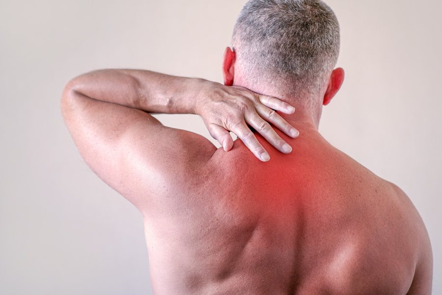 Man holding his back in pain from a pinched nerve