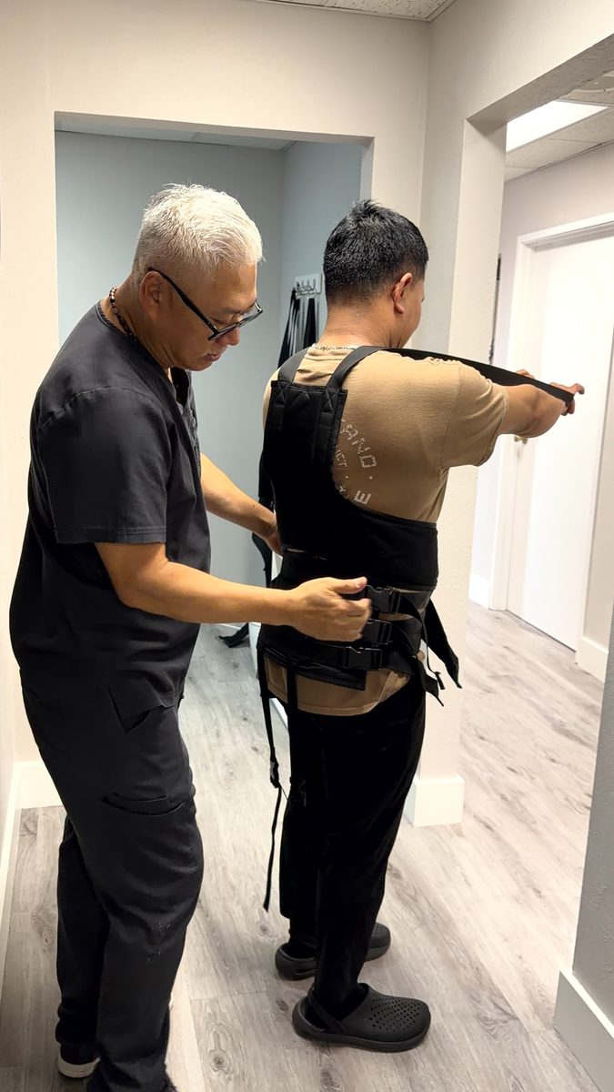 Patient being prepared for a spinal decompression session at Dallas Spine Center in Carrollton, TX